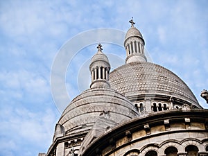 Church domes with intricate detail under blue sky with light clouds