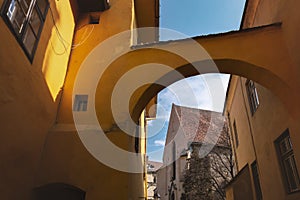 Church of the Dominican Monastery in Sighisoara, viewed through an archway