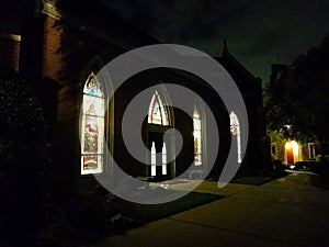 Church Door with Colorful Stained Glass Windows at Night