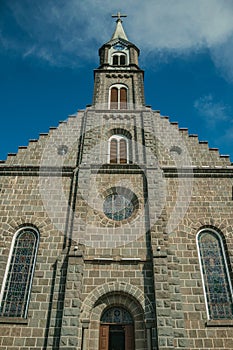 Church facade with steeple and cross in Gramado