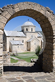 The church of the Gradac monastery is visible through the arch