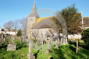 Church and grave yard with holly tree in Hove, East Sussex, United Kingdom