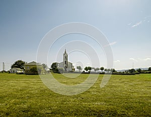 A church in a green meadow on a sunny day