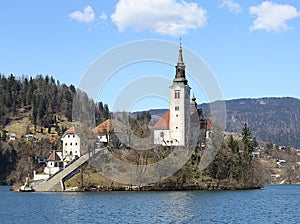 Church with a high Bell Tower on the island on Lake Bled in Slov