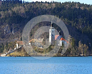 Church with a high Bell Tower on the island on Lake Bled in Slov