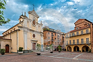 Church and historic house on small town square in Alba, Italy.