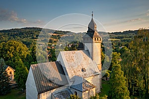 The church in historical Siedlecin town illuminated by the setting sun in the Bobr Valley Landscape Park, Lower Silesia. Poland