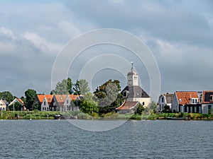 Church and houses of Durgerdam village from Buiten IJ river near Amsterdam, Netherlands