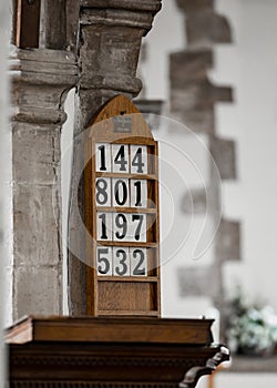 Church hymn numbers on wall of church