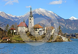 Church on the island of Lake BLED in SLOVENIA and the snowy mountains