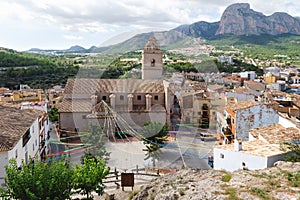 Church and main square of Polop de Marina with mountainrange, Costa Blanca, Spain