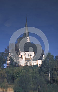 The Church of Marika Bozja reflected into the water. Bled, Slovenia