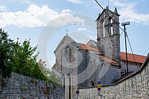 Church and Monastery of St. Francis, with stone walls on both sides and the sky at the background, in Pula, Croatia