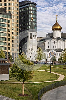 Church next to modern houses. Moscow, Russia, 09/30/2020