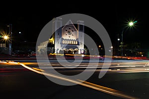 church at night with city lights