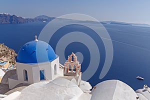 Church in Oia in front of caldera photo