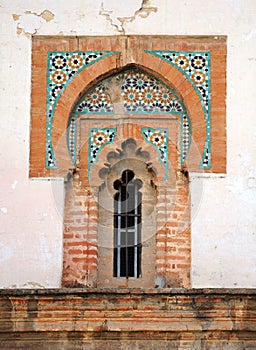 Mudejar style window with tiles -alicatados- of the church of Omnium Sanctorum in Seville, Spain photo