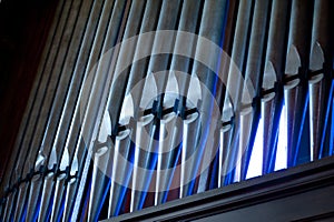 Church organ pipes with blue highlights