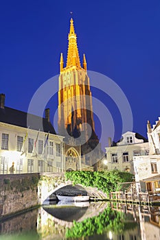 Church of Our Lady and canal illuminated in the night. Bruges, Belgium