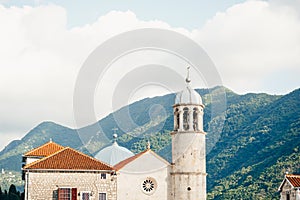 Church of Our Lady on the rocks on the island of Gospa od Skrpjela against the backdrop of mountains