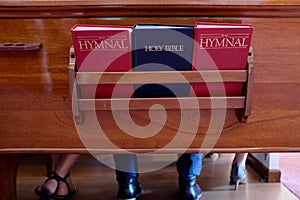 Church Pew With Bible and Hymnal Books