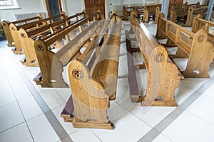 Church pews awaiting worshipers to pray