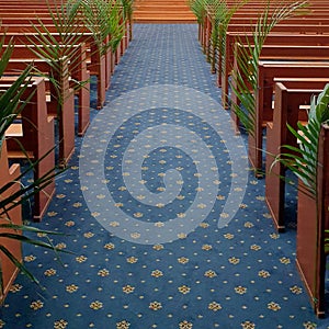 church pews with palm tree branches inside place of worship