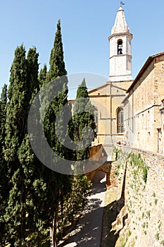 Church in PIenza, Tuscany, Italy with cypress trees