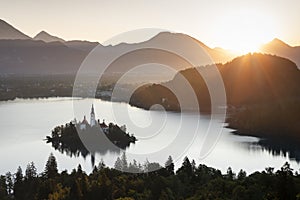 Church of pilgrimage Mariä Himmelfahrt on island in Lake Bled during sunrise, Bled Slovenia