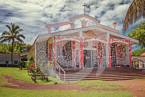 Church with red decorations in the beautiful village of Hanga Roa on Easter Island, Chile photo