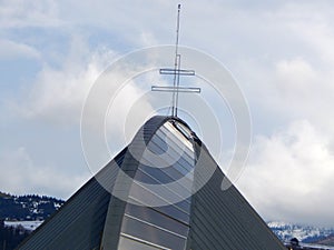 Church roof with a cross on top