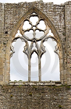 Gothic window detail with grey sky
