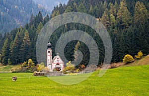 The church of Saint John, Ranui,  Chiesetta di san giovanni in Ranui Runes South Tyrol Italy, surrounded by green meadow, forest