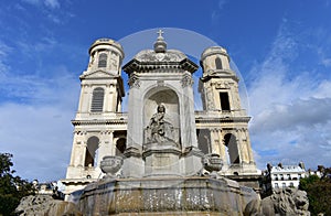 Church of Saint Sulpice neoclassical facade with fountain. Paris, France.