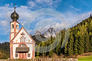 Church of San Giovanni against the Geisler peaks in Santa Maddalena village, Val Di Funes in Dolomites mountains
