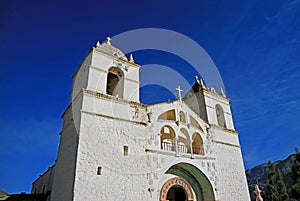 Church of Santa Ana de Maca against vivid blue sky, Colca canyon, Arequipa region, Peru photo