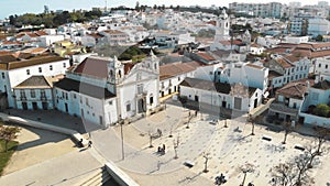 Church of Santa Maria de Lagos in the Old town Square, in Algarve, Portugal - Aerial Panoramic Ascending shot