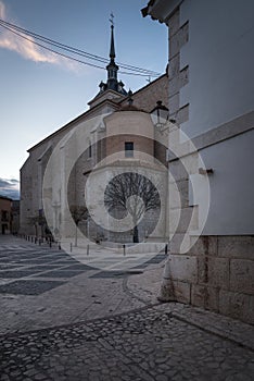 The church of Santa MarÃÂ­a la Mayor at sunset with a cloud in the sky, Colmenar de Oreja, Spain photo