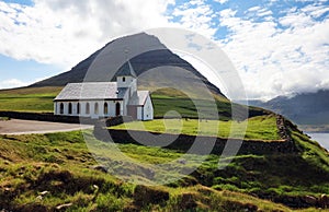 Church by the sea with ocean and mountain panorama, Vidareidi, Faroe Islands, Denmark, Northern Europe