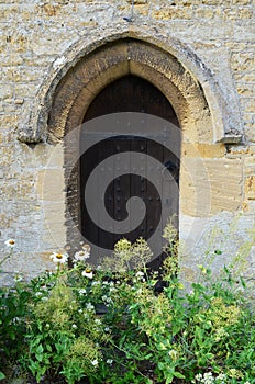 Church side door with wild flowers