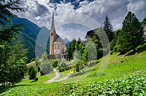 A church sits amongst mountainous terrain in Heiligenblut, Austria