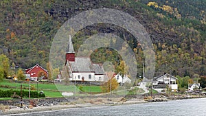 Church of Skjolden at the shore of the Lusterfjord in autumn in Norway