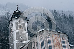 Church in snow storm. Frozen environment. Religious building.
