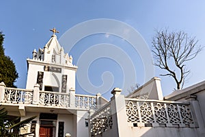 The church spire in the blue sky.