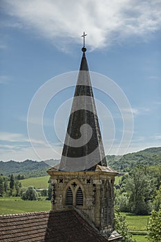 Church spire, with green fields in background