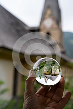 Church St Alban in Matrei in Osttirol through a glass sphere