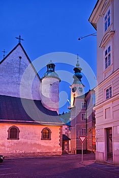 The church of St. Catherine and Town Hall in Banska Stiavnica town during autumn evening