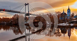 The Church of St. John Chrysostom and the bridge on the bank of the Moskva River at sunset on an autumn day. Autumn rural