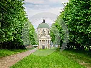 Church of St. Joseph against of linden alley. Pidhirtsi, Ukraine