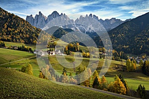 Church of St. Magdalena in front of the Geisler or Odle Dolomites mountain peaks. Val di Funes in South Tyrol. Italy.